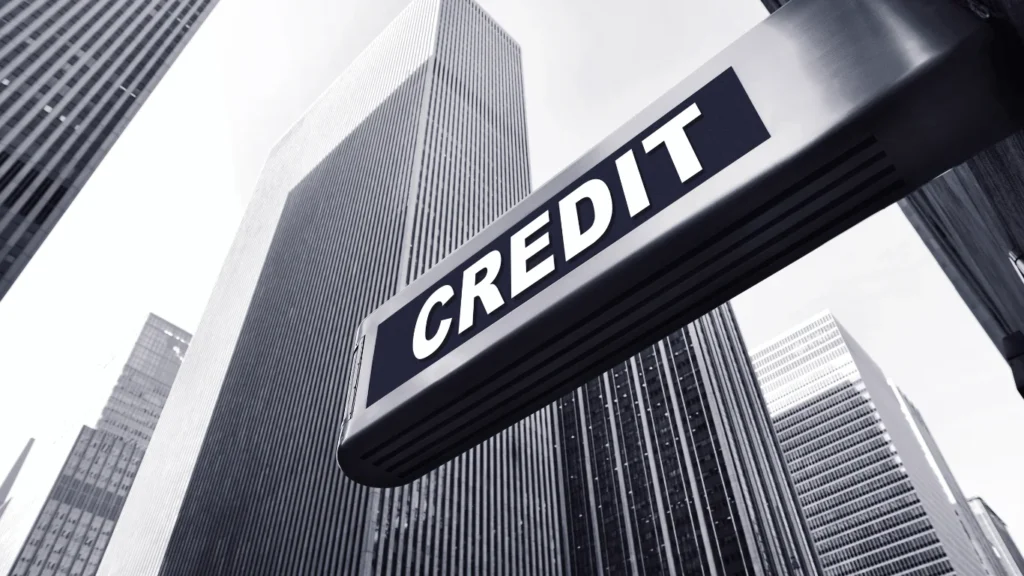 Credit sign on building amidst skyscrapers, symbolizing financial literacy and credit management.